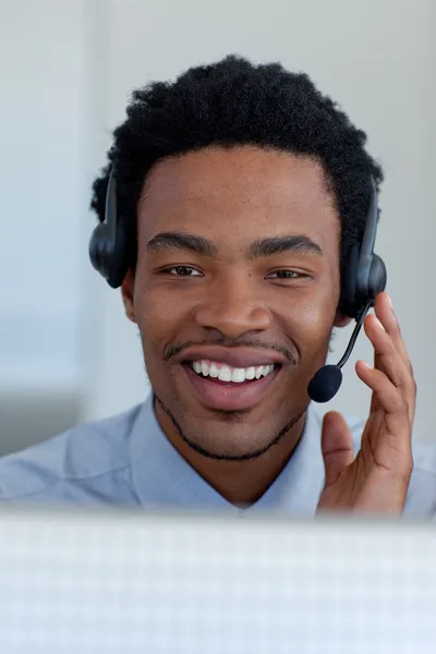 Jovem empresário afro-americano em um call center — Fotografia de Stock