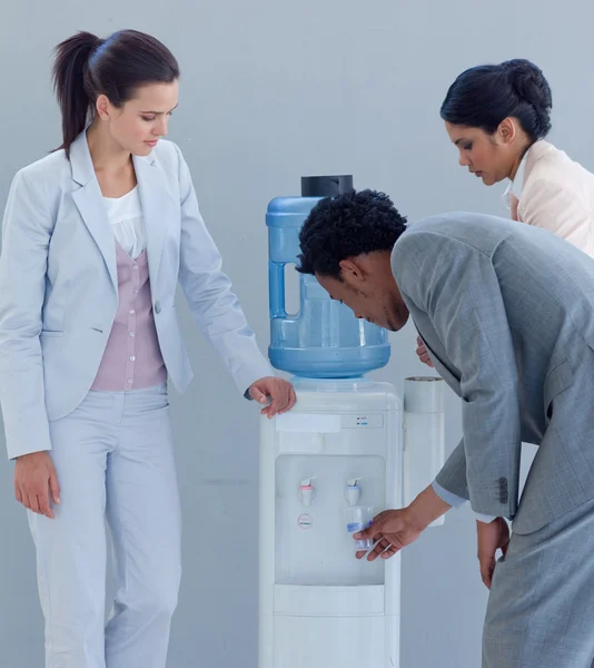 Negócios bebendo de um refrigerador de água — Fotografia de Stock