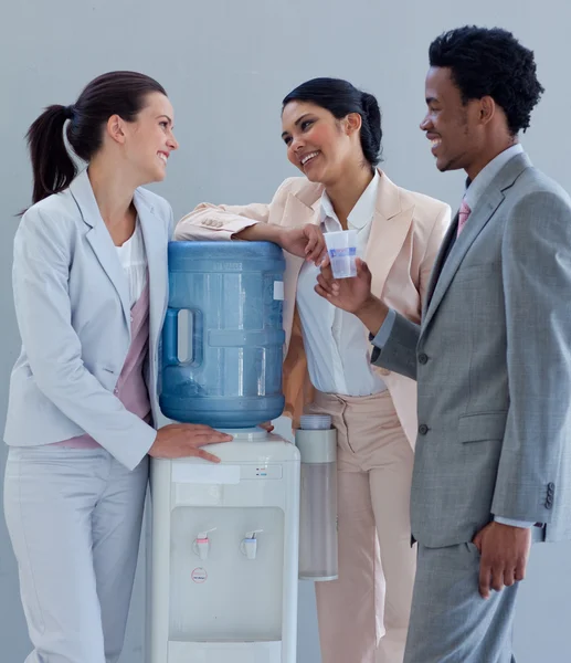 Business speaking next to a water cooler