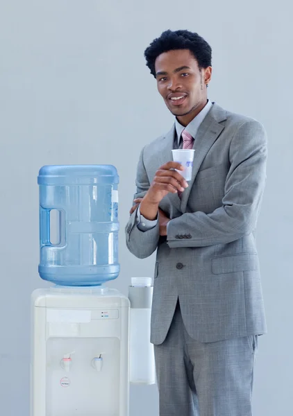 Businessman with a water cooler in office — Stock Photo, Image