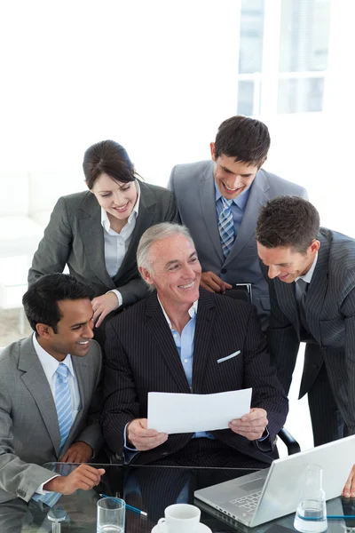 Senior manager showing sales report to his colleagues — Stock Photo, Image