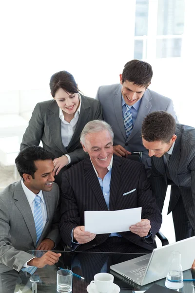 Businessman showing a contract to his team — Stock Photo, Image