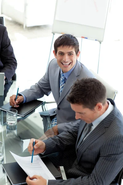 Young businessman smiling at the camera in a meeting — Stock Photo, Image