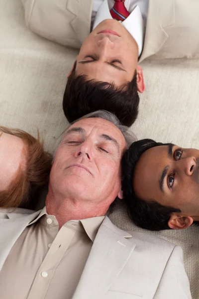 International Business team lying on the floor — Stock Photo, Image