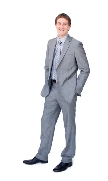 Positive businessman standing with hands in pockets — Stock Photo, Image