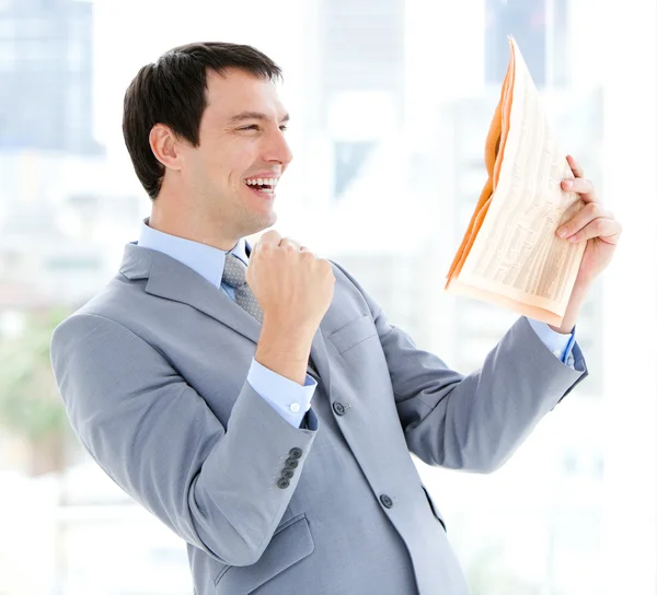 Happy businessman reading a newspaper — Stock Photo, Image
