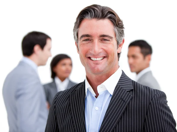 Charismatic mature businessman standing with his team — Stock Photo, Image