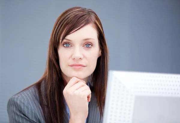 Confident businesswoman working at a computer — Stock Photo, Image