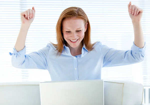 Radiant business woman punching the air — Stock Photo, Image