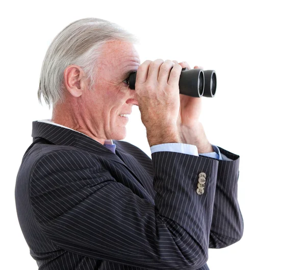 Senior businessman looking through binoculars standing — Stock Photo, Image
