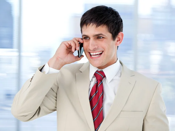 Laghing businessman talking on phone standing — Stock Photo, Image