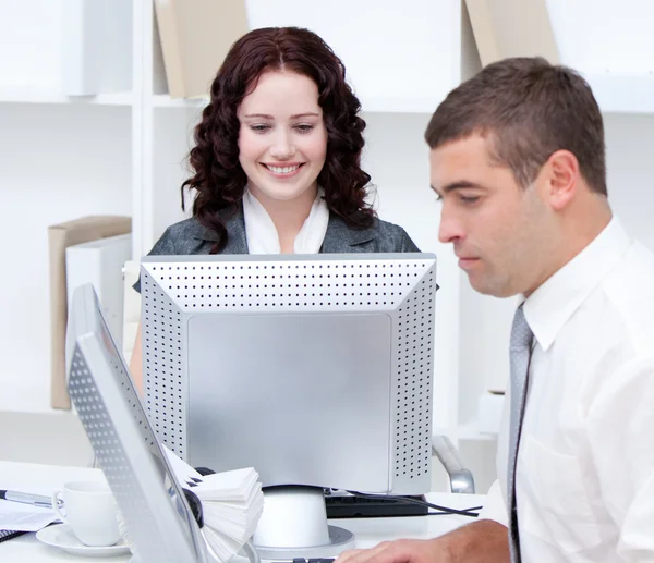 Self-assured young business working at computers — Stock Photo, Image