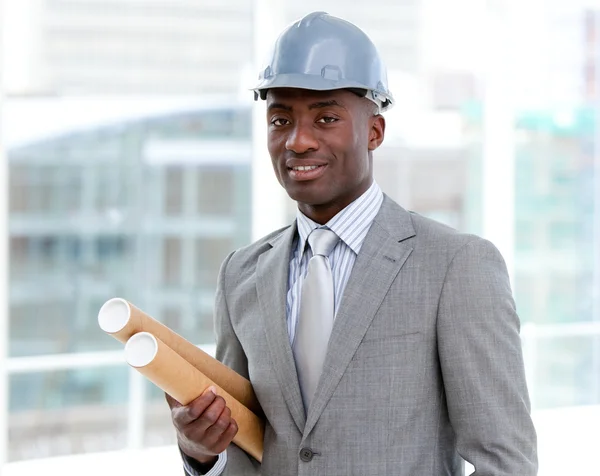 Portrait of a charismatic male architect holding blueprints — Stock Photo, Image