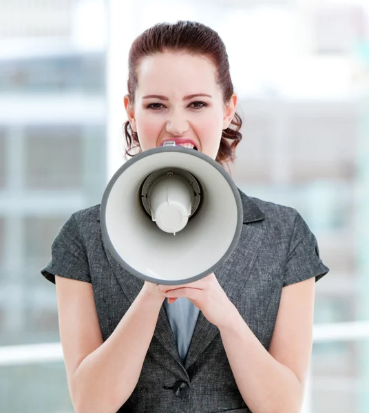 Woedend zakenvrouw schreeuwen via een megafoon — Stockfoto