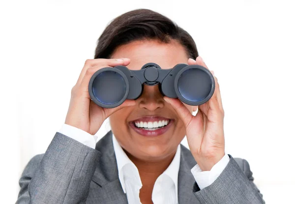 Assertive businesswoman looking through binoculars — Stock Photo, Image