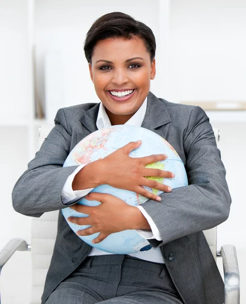 Charismatic businesswoman holding a terrestrial globe — Stock Photo, Image