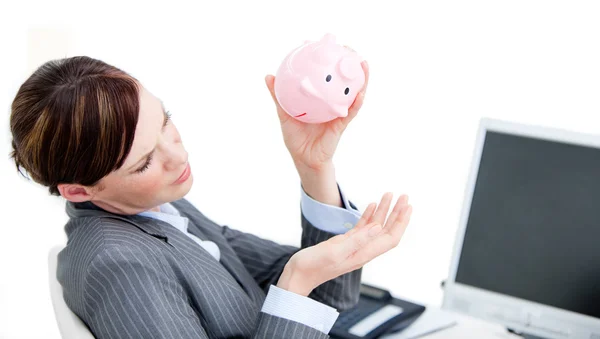 Upset businesswoman holding a piggy-bank — Stock Photo, Image