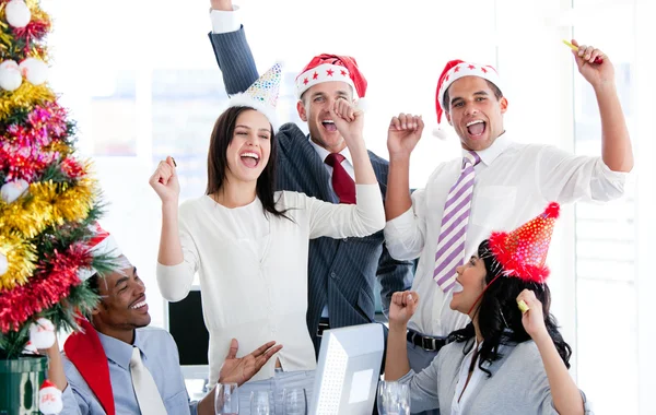 Business team punching the air to celebrate christmas — Stock Photo, Image