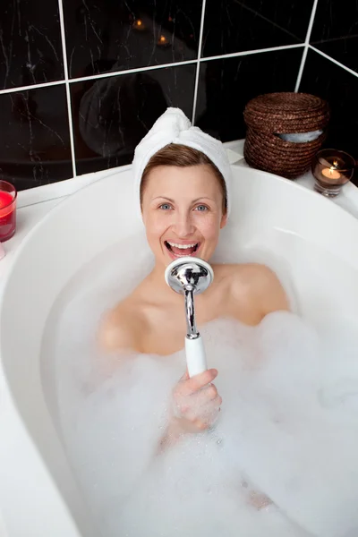 Mujer feliz cantando en un baño de burbujas —  Fotos de Stock