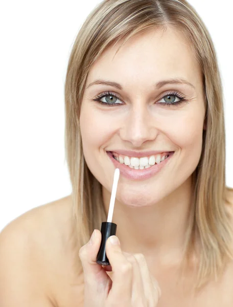 Smiling woman putting gloss — Stock Photo, Image