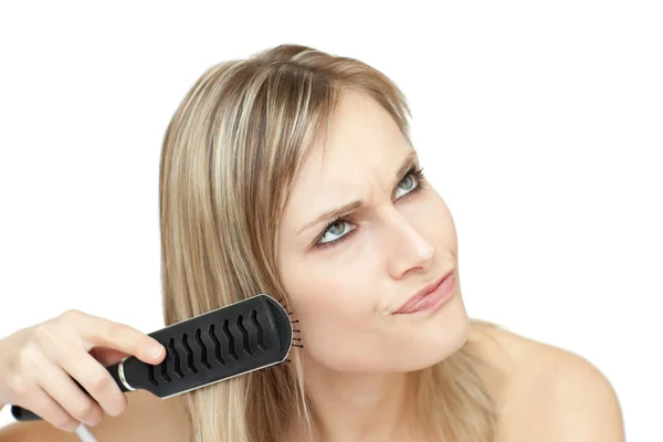 Annoyed woman bruishing her hair — Stock Photo, Image