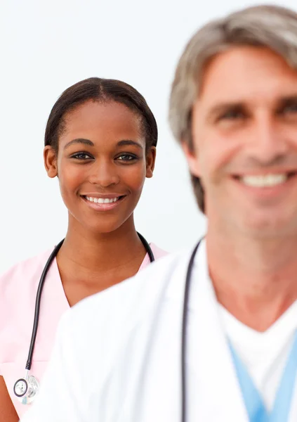 Portret van twee positieve artsen tegen een witte achtergrond — Stockfoto