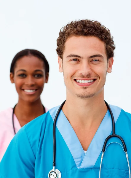 Portret van twee positieve artsen tegen een witte achtergrond — Stockfoto