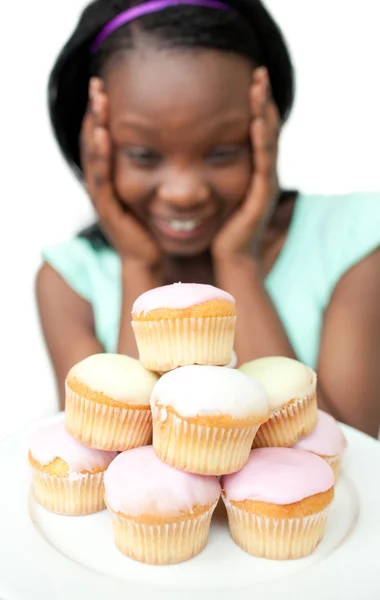 Jolly young woman looking at cakes — Stock Photo, Image