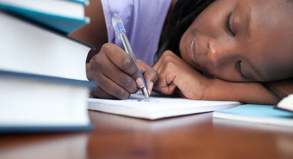 Close-up of a tired afro-american teen girl studying — Stock Photo, Image