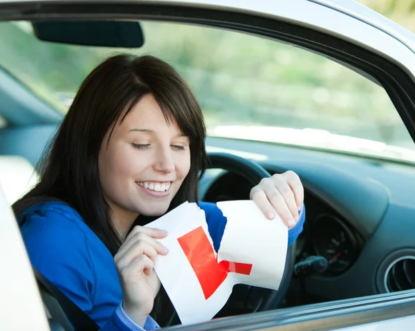 Brünettes Teenie-Mädchen sitzt in ihrem Auto und reißt ein L-Zeichen — Stockfoto