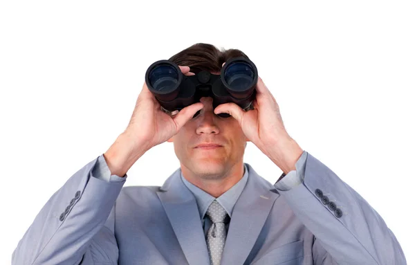 Serious businessman looking through binoculars — Stock Photo, Image
