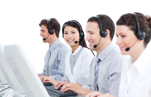 Multi-cultural customer service agents working in a call center — Stock Photo, Image