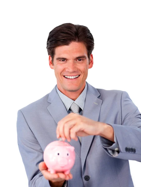 Charismatische zakenman geld te besparen in een piggy-bank — Stok fotoğraf