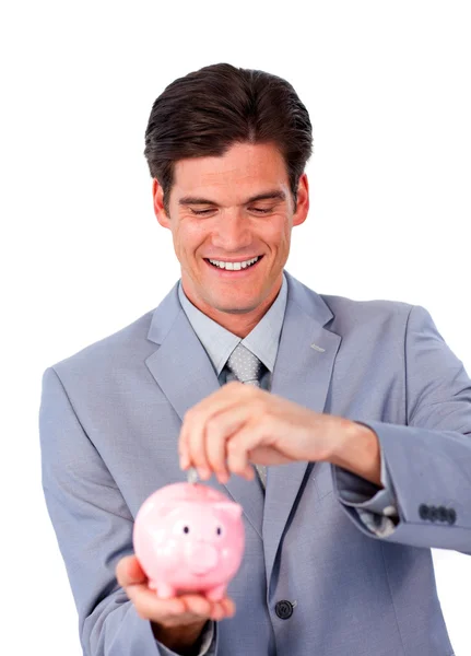 Assertive businessman saving money in a piggy-bank — Stock Photo, Image