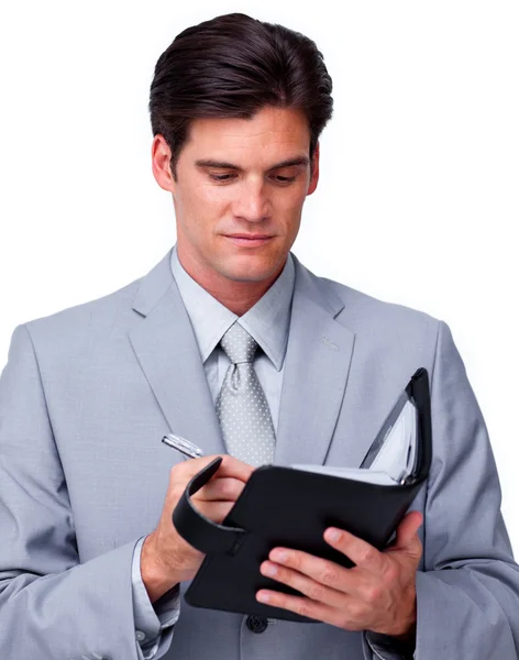 Concentrated businessman consulting his agenda — Stock Photo, Image