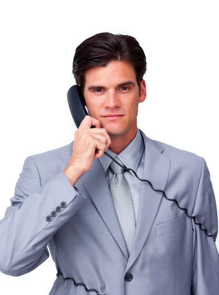 Sério masculino executivo emaranhado em fios de telefone — Fotografia de Stock