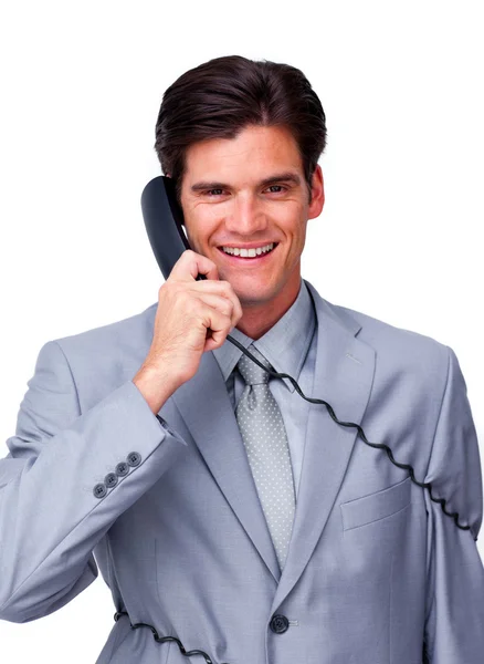 Sorrindo masculino executivo emaranhado em fios de telefone — Fotografia de Stock