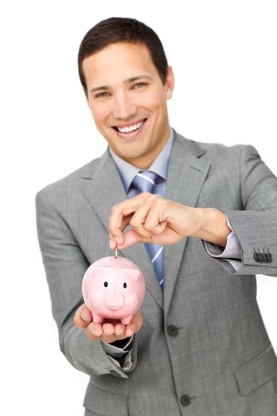 Empresário alegre economizando dinheiro em um banco porquinho — Fotografia de Stock