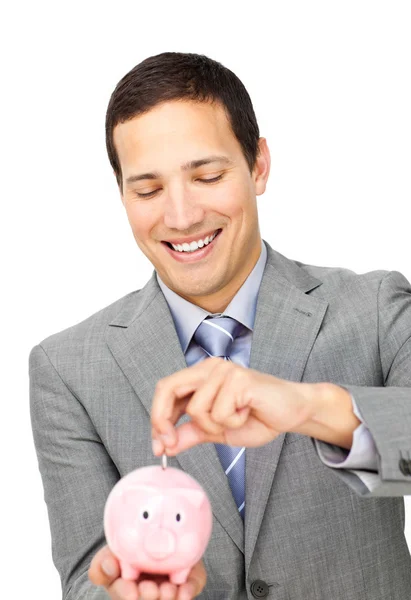 Empresário atraente economizando dinheiro em um banco porquinho — Fotografia de Stock