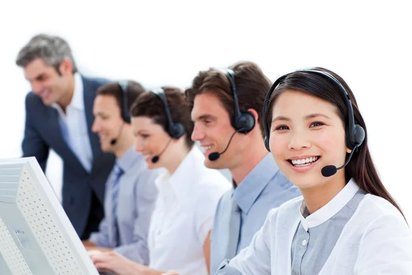 Positive business team talking on headset — Stock Photo, Image