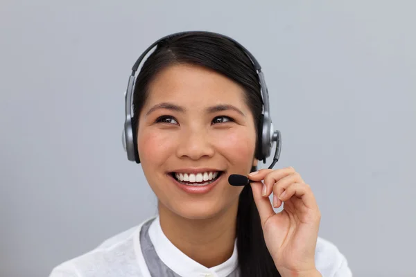 Beautiful young businesswoman using headset — Stockfoto
