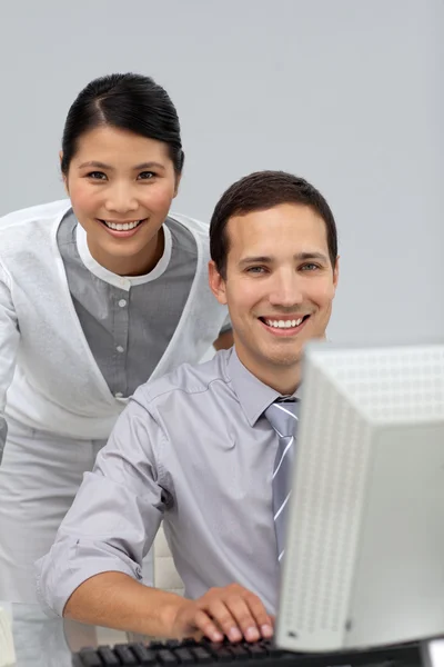 Assertive Asian businesswoman helping her colleague — Stockfoto