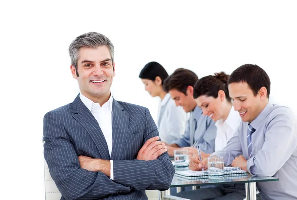 Mature manager and his team writting notes in a meeting — Stock Photo, Image