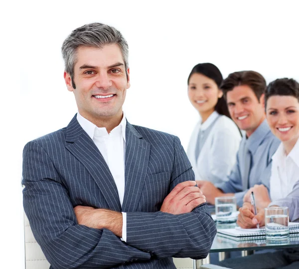 Confident manager sitting in front of his team — Stock Photo, Image