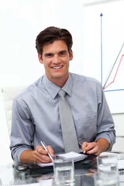 Male executive consulting his agenda in a meeting — Stock Photo, Image