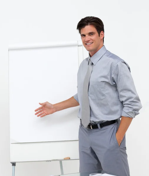 Self-assured businessman pointing at a board — Stock Photo, Image