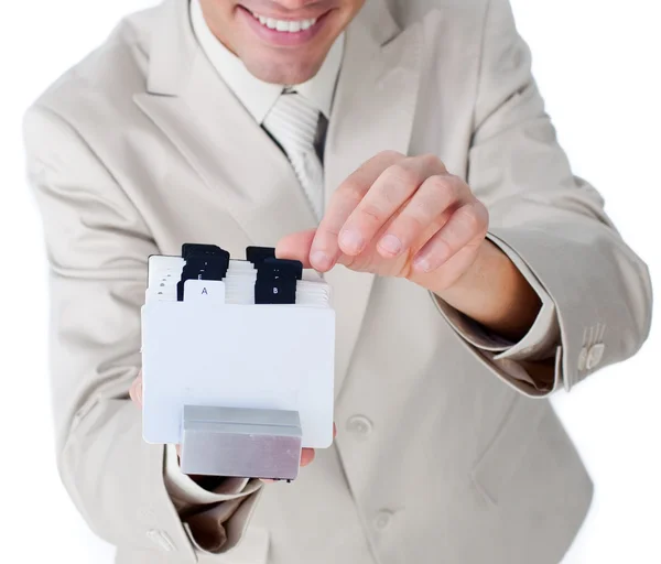 Close-up of businessman consulting a business card holder — Stock Photo, Image
