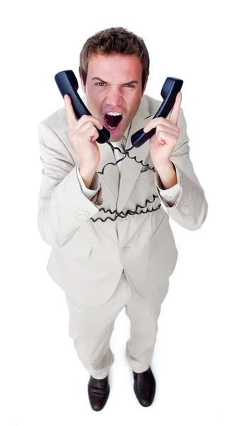 Gestresster Geschäftsmann, der sich in Telefondrähten verheddert — Stockfoto