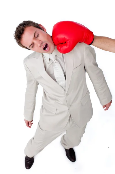 Joven hombre de negocios siendo golpeado con un guante de boxeo — Foto de Stock