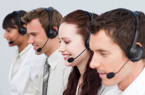 Beautiful woman working with other in a call center — Stock Photo, Image